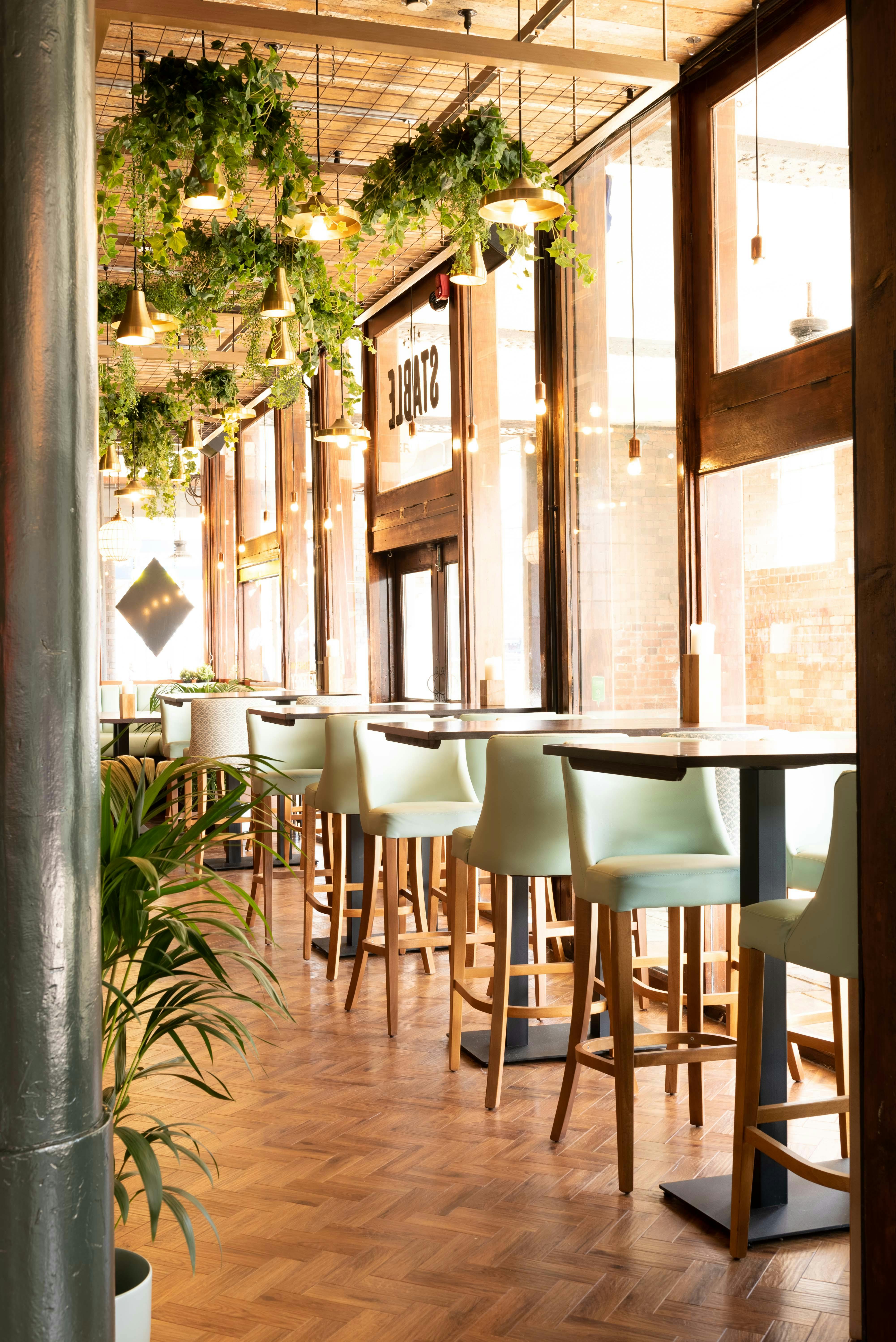 Modern venue hire in The Bristol Stable with high tables and natural light for networking events.