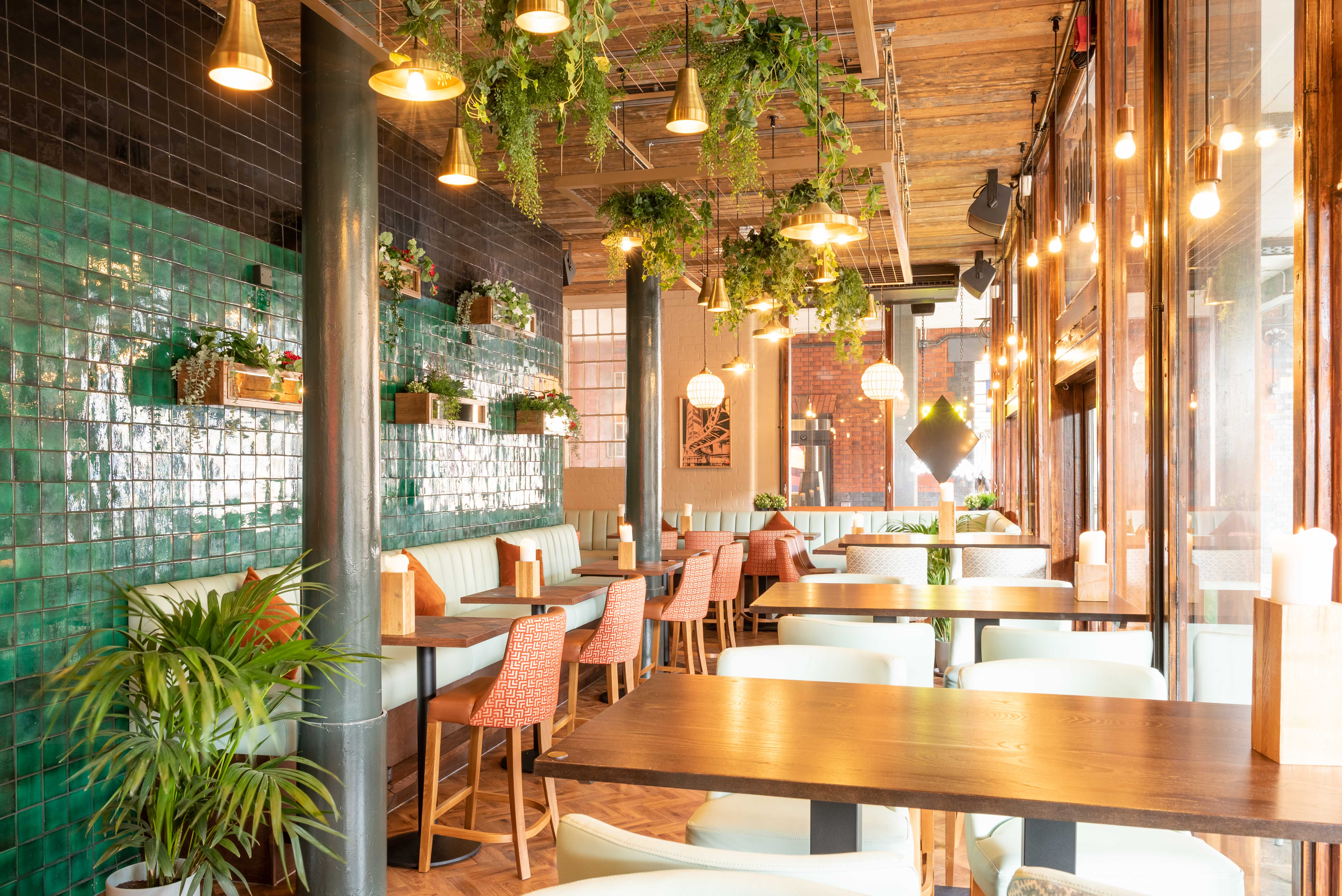 Stylish restaurant interior with green tiles, ideal for networking events and gatherings.