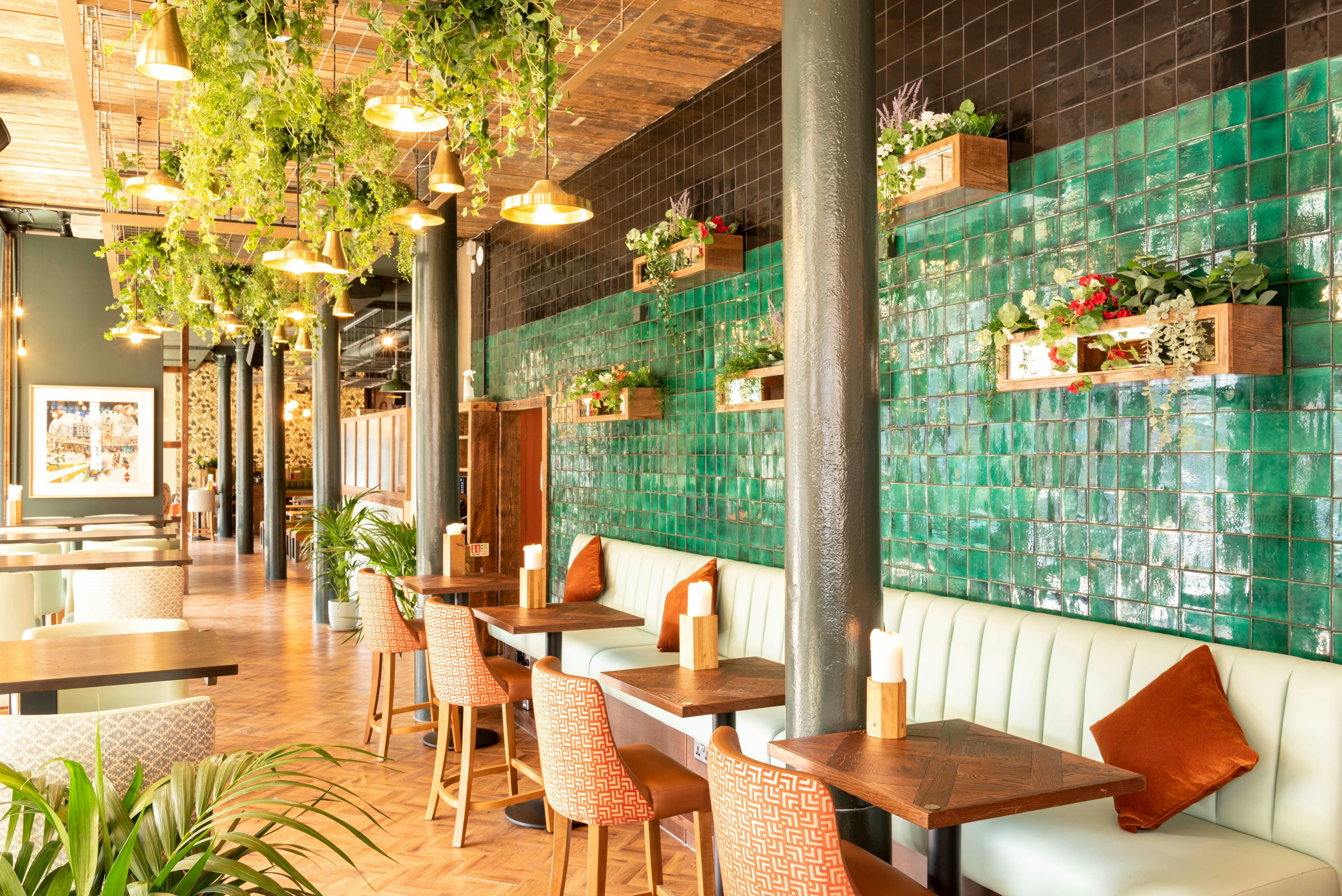 Stylish restaurant interior with green tiles, ideal for events and gatherings.
