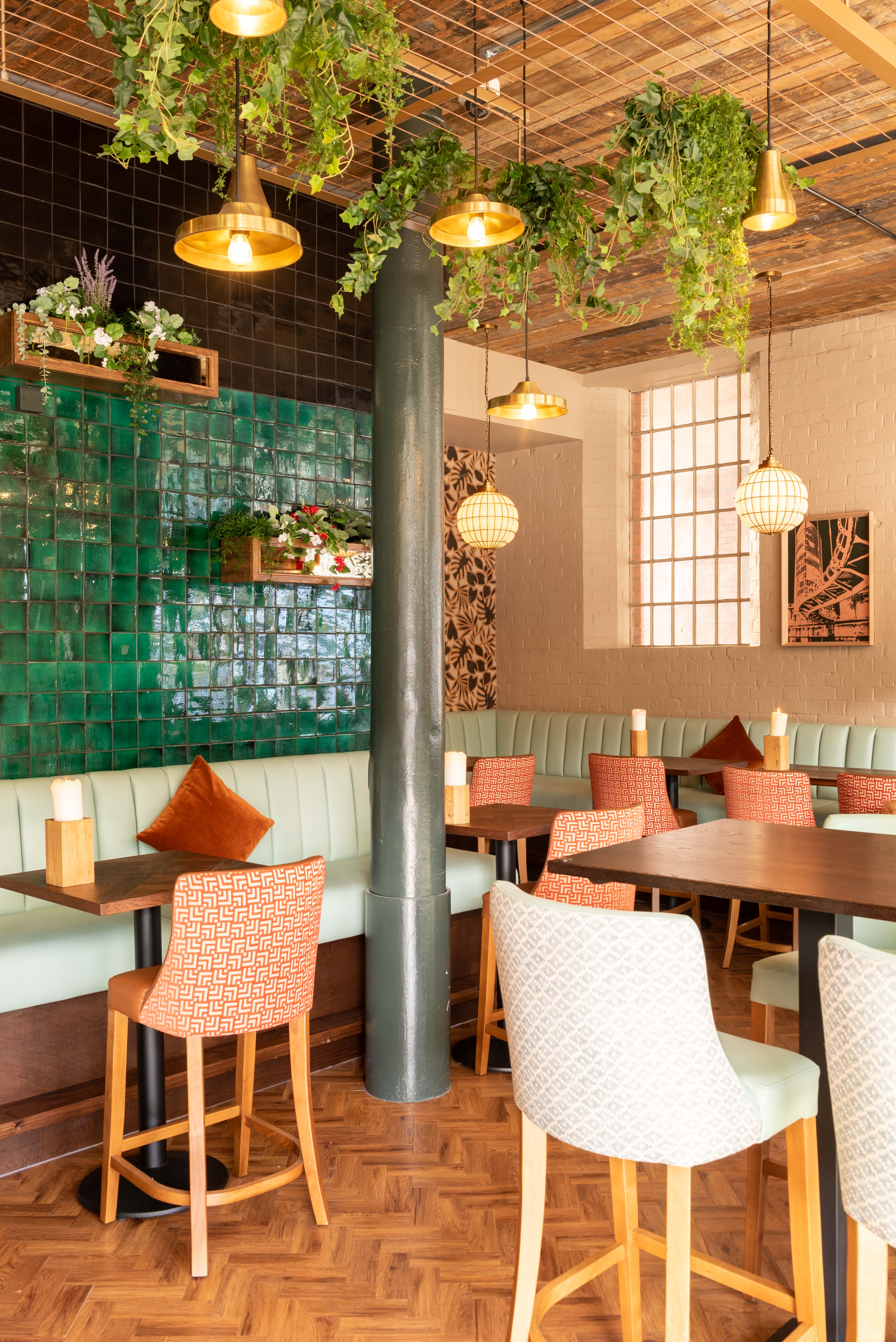 Stylish dining space with green tile wall, ideal for corporate meetings and networking events. - Banner