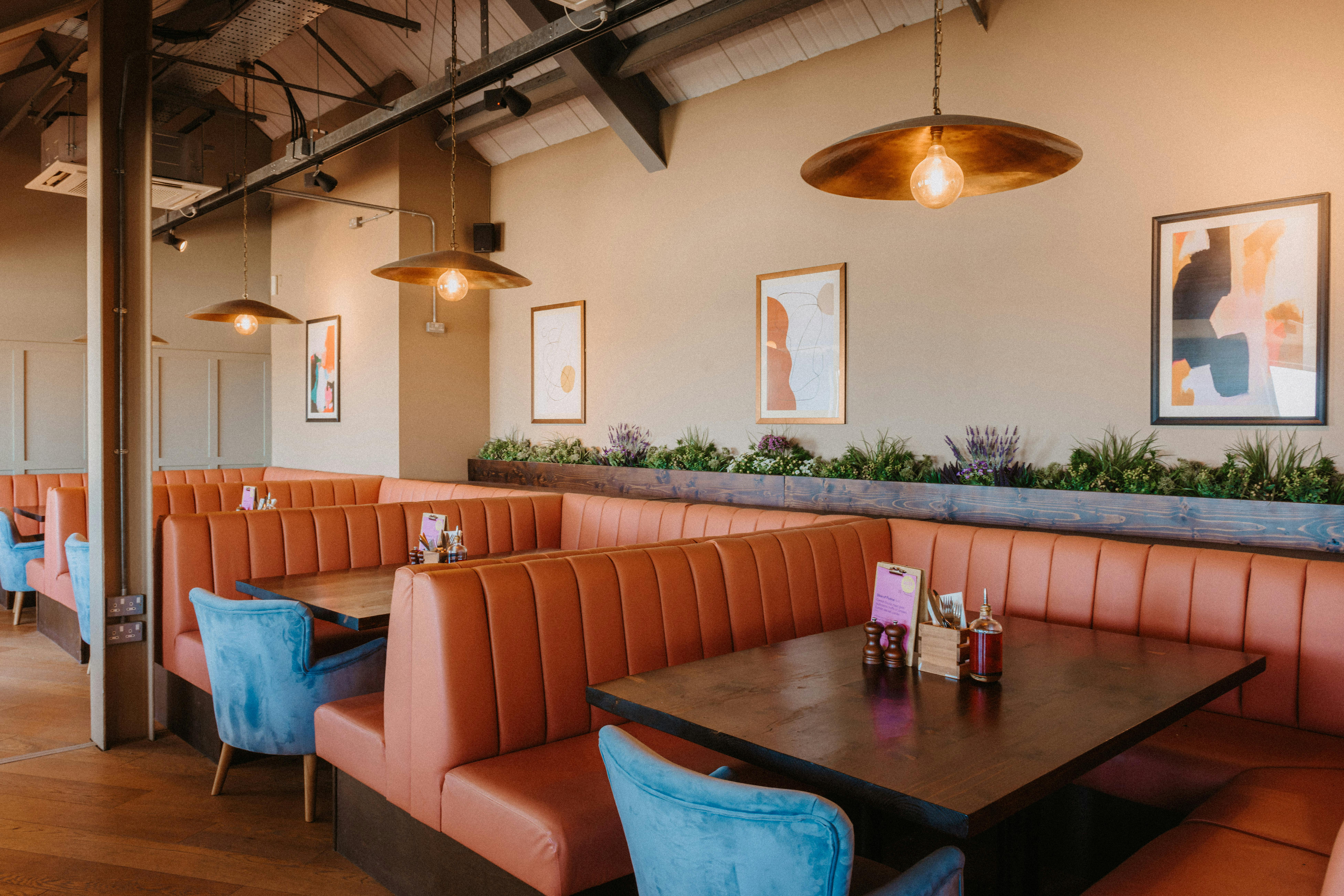 Stylish restaurant interior with cozy booths, ideal for intimate events and meetings.