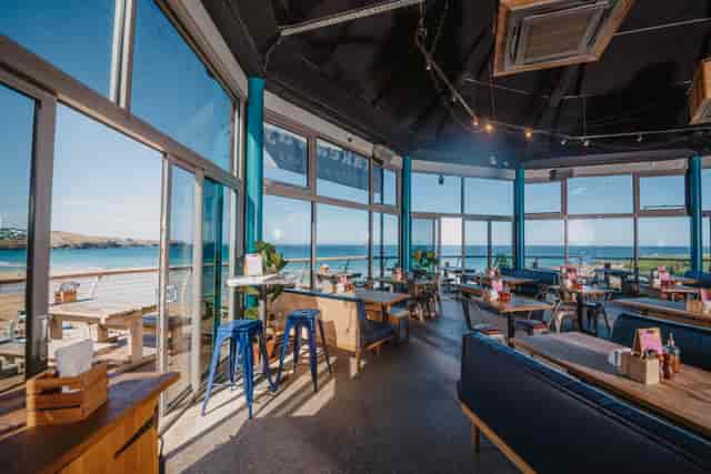 Bright event space with panoramic water views, ideal for meetings and gatherings.