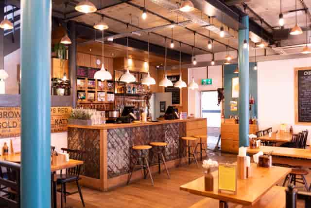 Modern café venue with warm wood accents for networking events and meetings.
