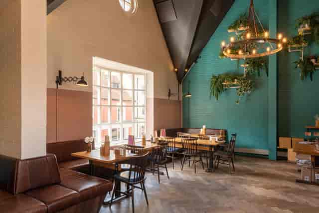 Stylish event space with high ceilings, ideal for workshops and networking events.