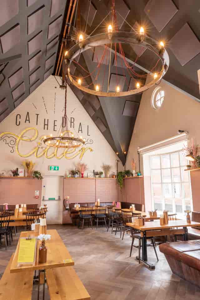 Stylish event space with high ceiling and modern chandeliers for gatherings and celebrations.