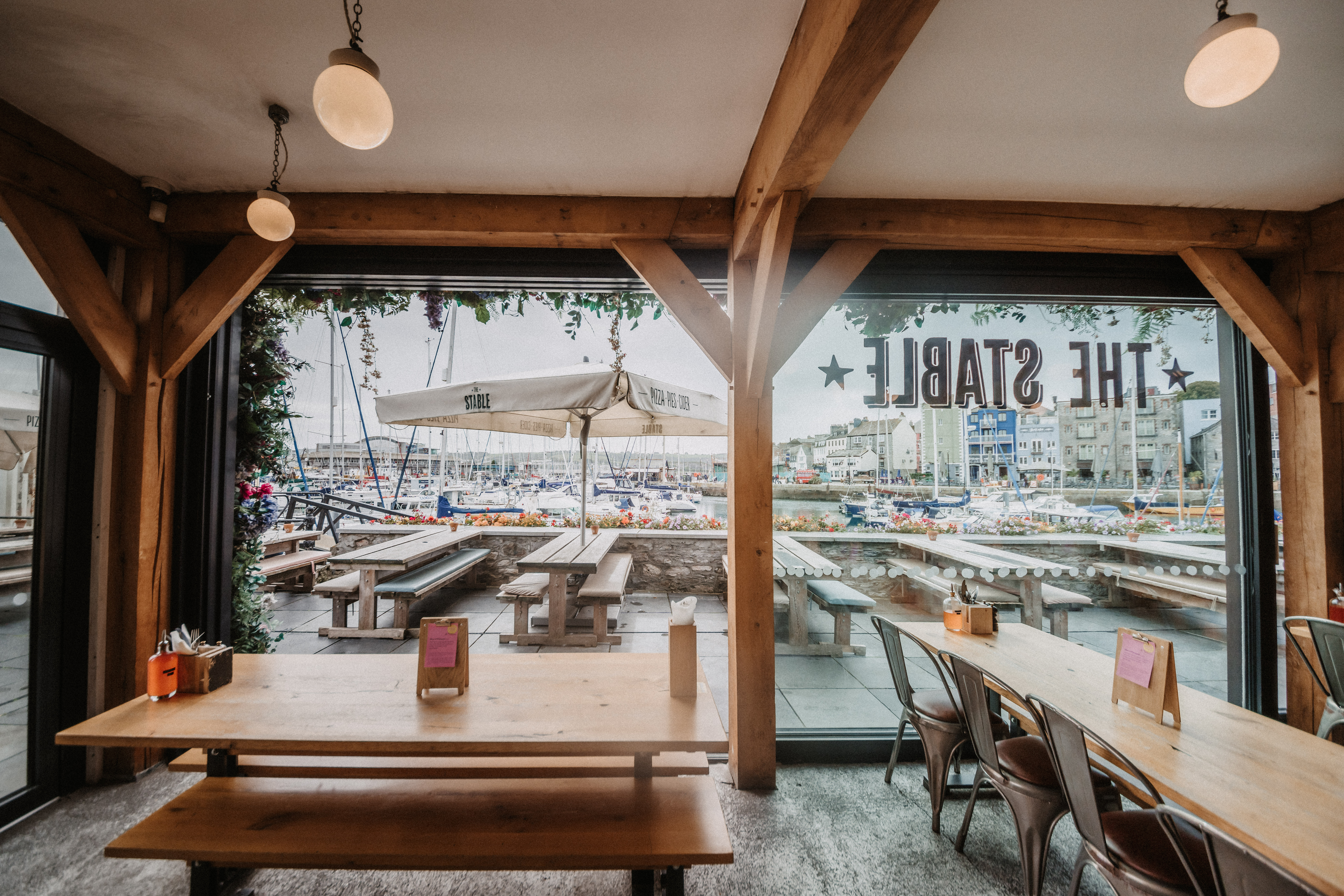 Stylish venue with wooden beams for networking events at The Plymouth Stable. - Banner