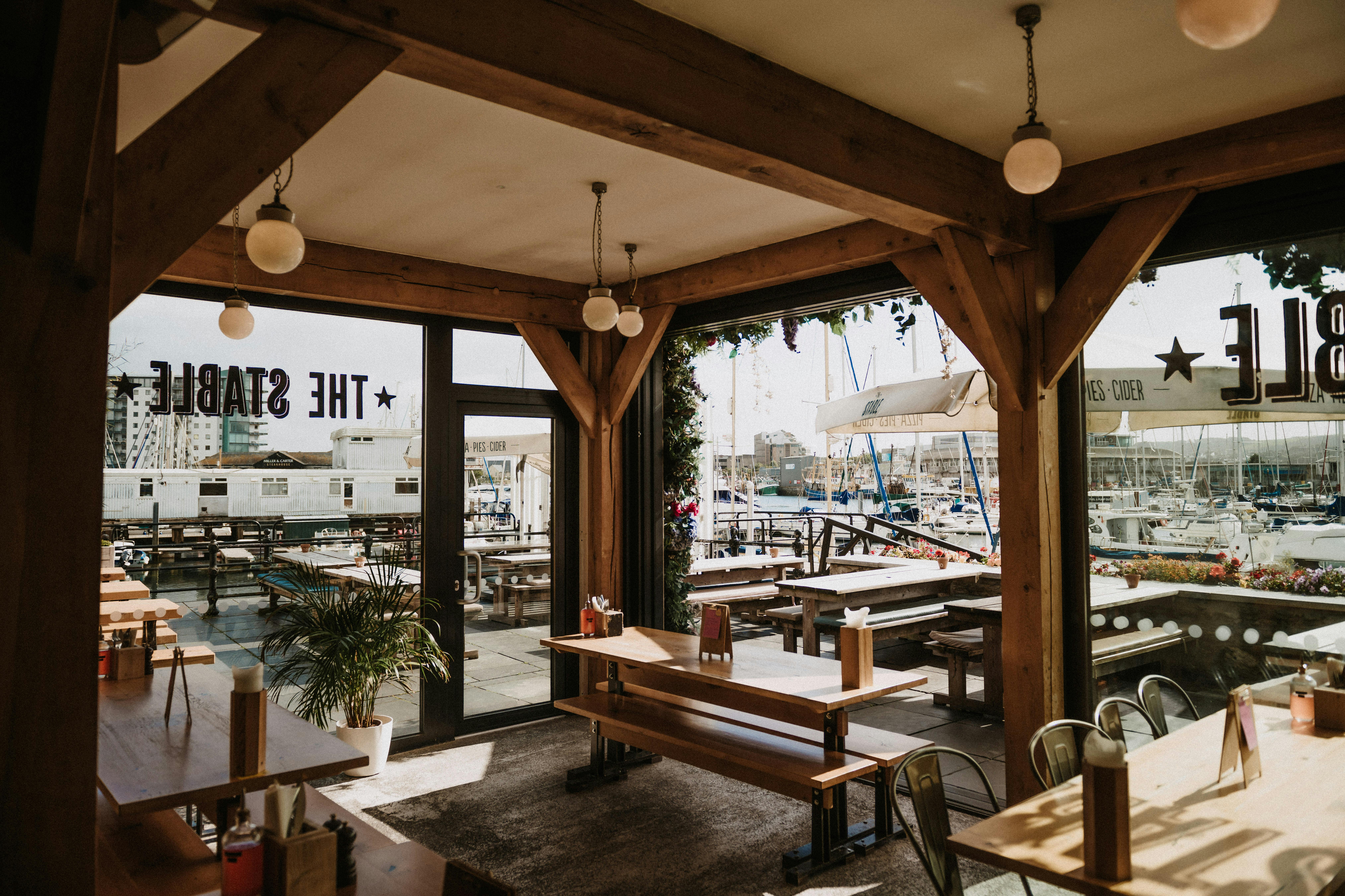 Harbour View Conservatory: rustic event space with marina views, ideal for gatherings and meetings.