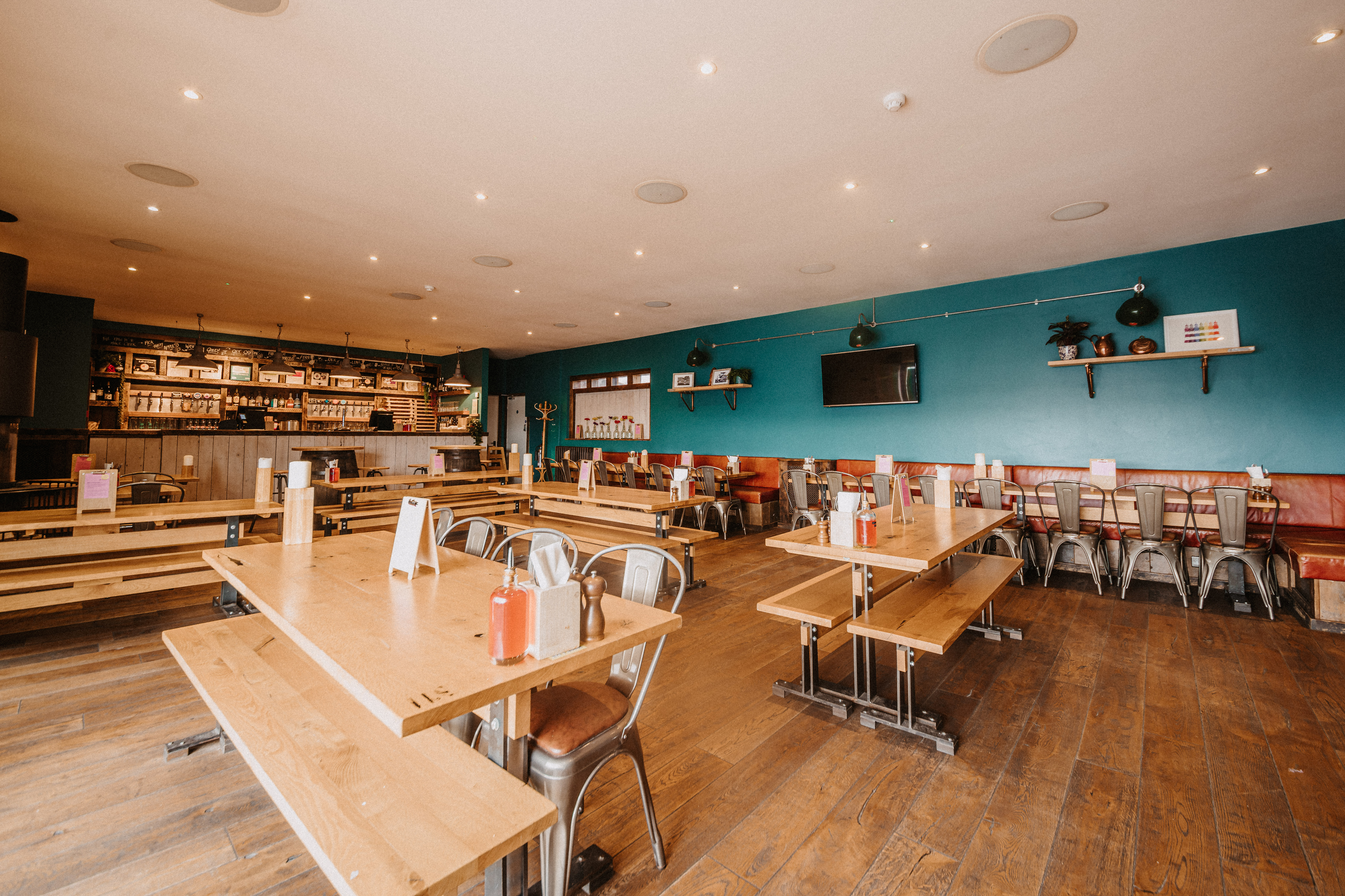 Spacious Top Deck venue with blue accent wall, perfect for networking events and gatherings.