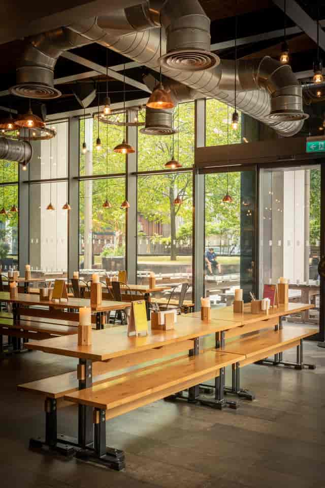 Modern dining space with large windows for networking events and team lunches.