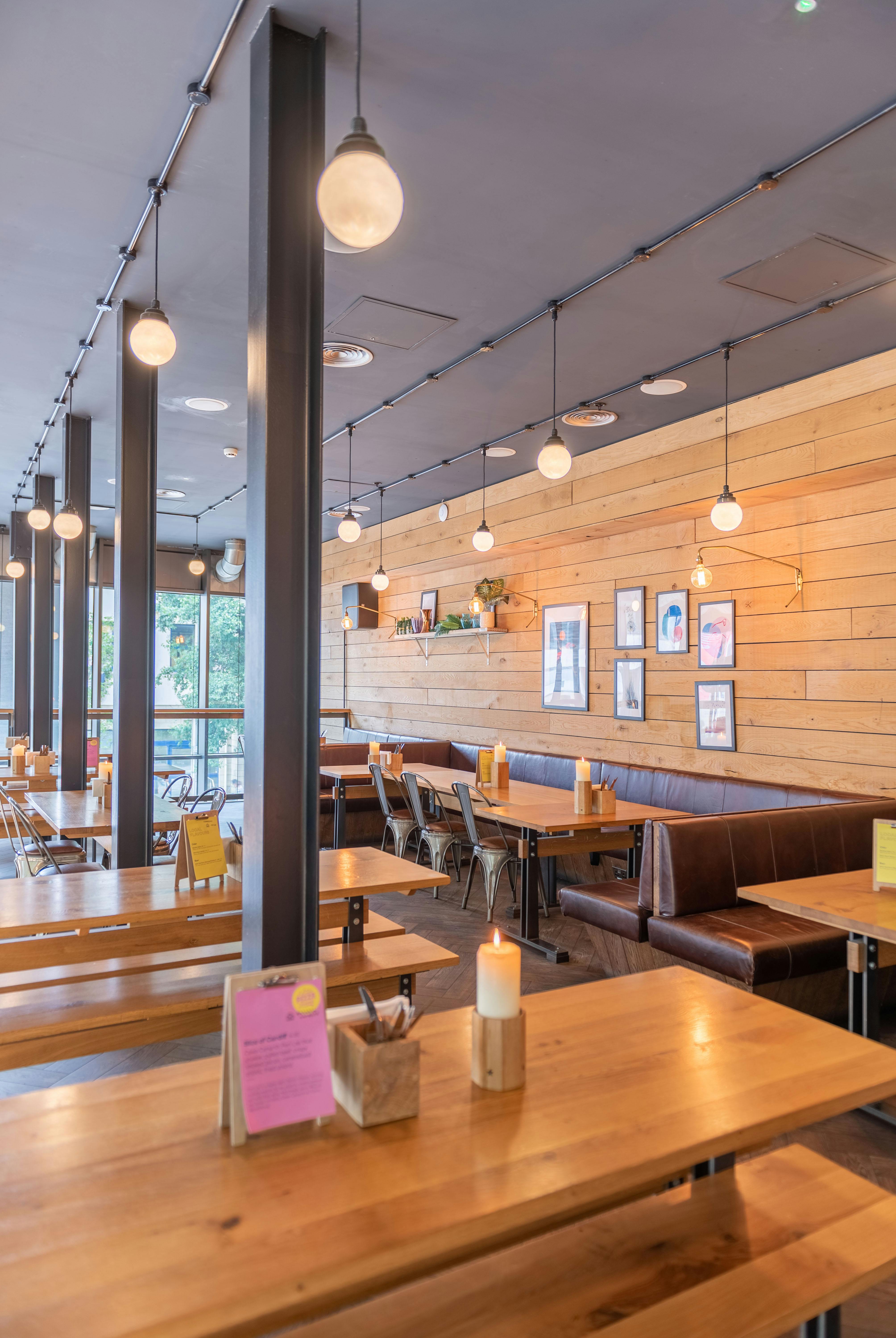 Modern restaurant space with warm wood accents, ideal for casual meetings and events.