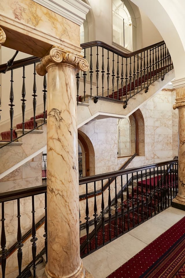 Horton Suite staircase at Macdonald Burlington Hotel, elegant marble for formal events.
