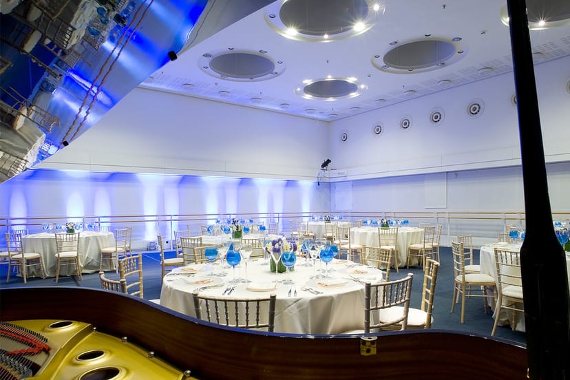 Paul Hamlyn Hall set for a formal dinner, featuring elegant tables and ambient lighting.