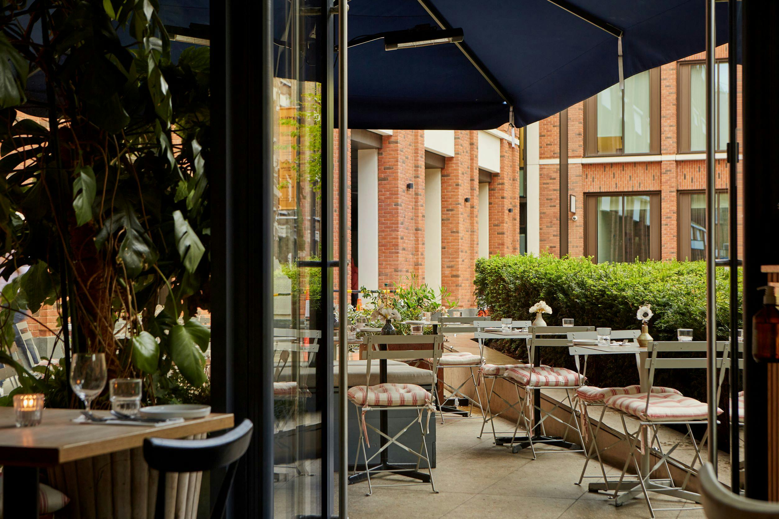 Crispin Pavilion outdoor dining area with modern furnishings for networking events.