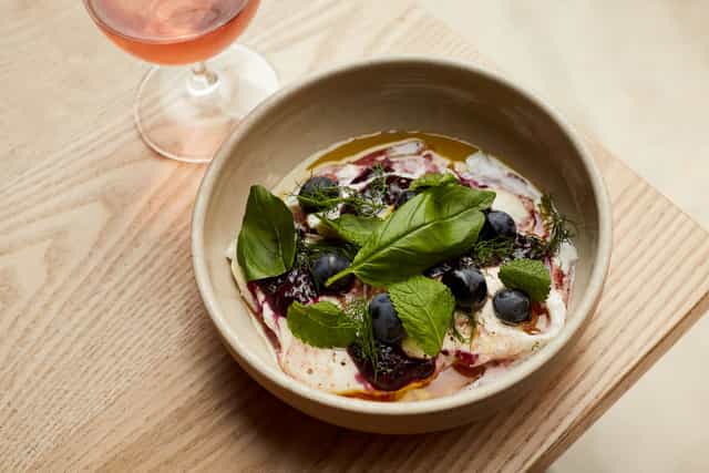 Crispin Pavilion dish with blueberries and rosé for elegant event catering.