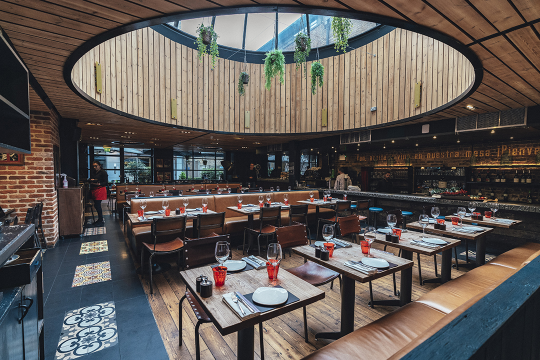 Modern restaurant interior with skylight, perfect for corporate events and gatherings. - Banner