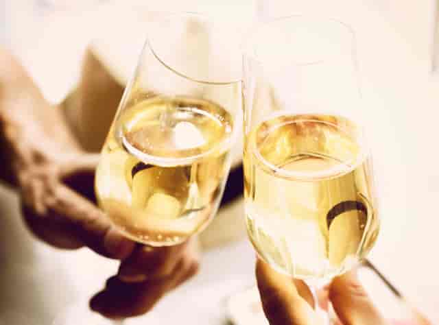 Champagne flutes in elegant venue, ideal for networking and milestone events.