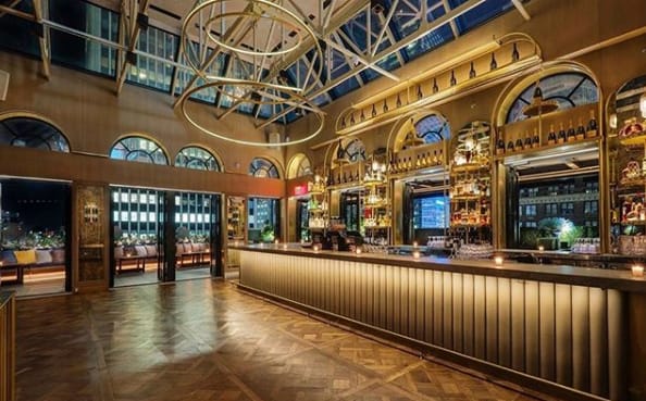 Elegant rooftop bar venue with high ceilings for upscale events and receptions.