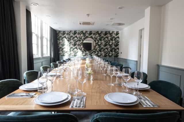 Elegant dining room with fine china, perfect for meetings and gatherings.