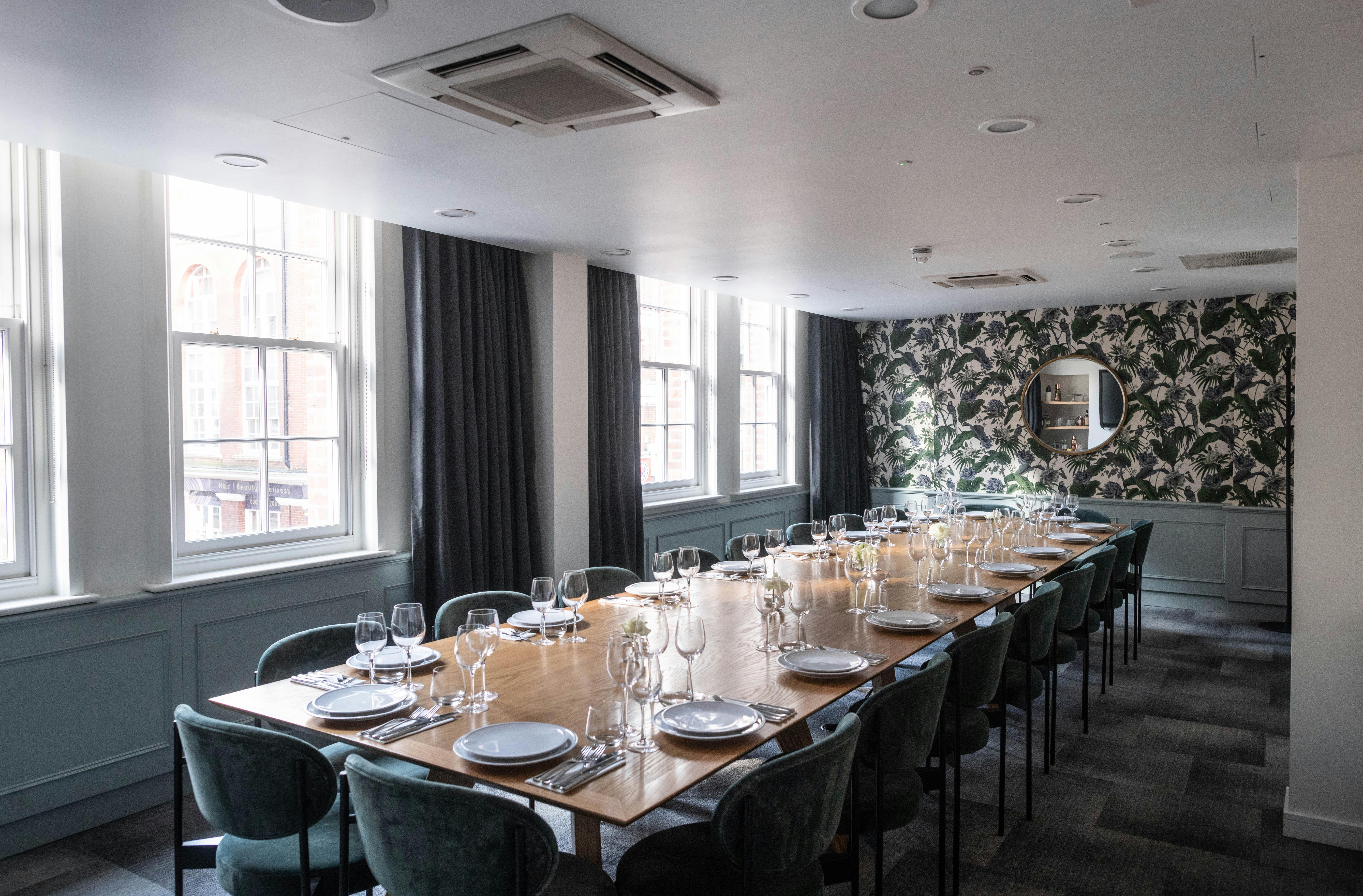 Stylish meeting room with wooden table, perfect for intimate gatherings and events.