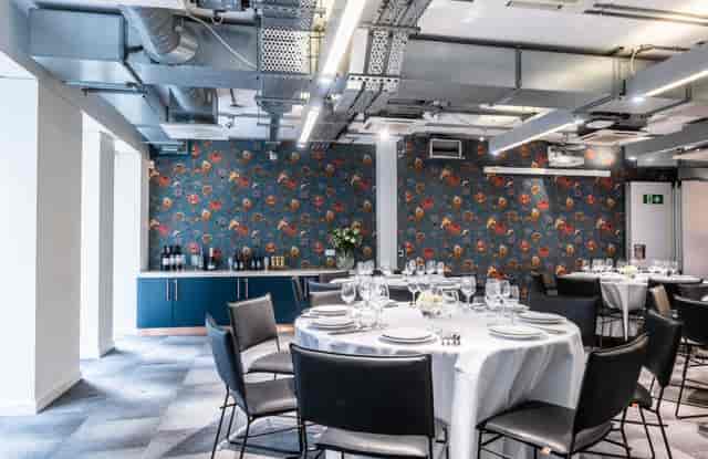 Elegant event space in Covent Garden with round tables for corporate gatherings.