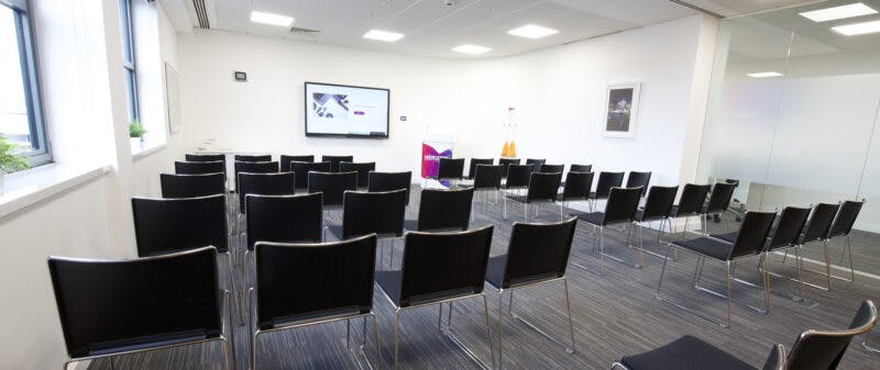 Meeting room at Inspire@ Horizon Leeds with sleek black chairs for presentations.