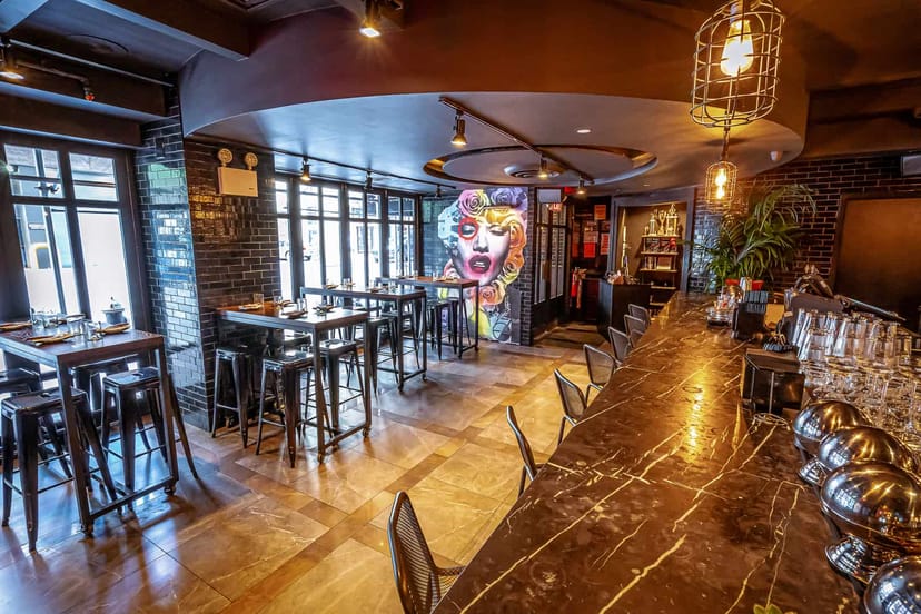 Modern event space with marble bar, ideal for networking and social gatherings.