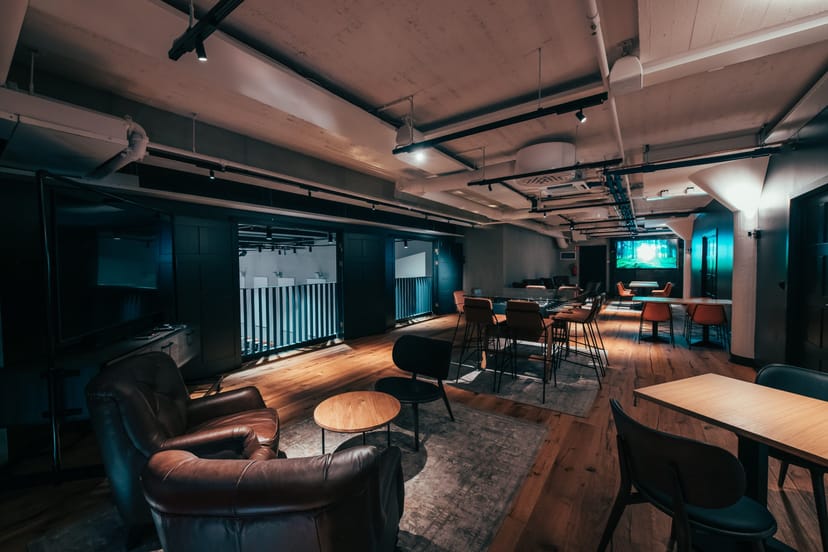 Versatile event space at Hotel Mestari with warm lighting for meetings and networking.