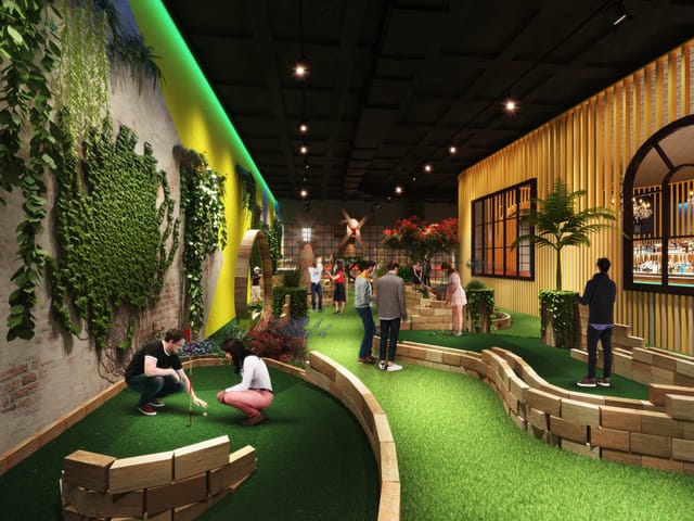 Vibrant indoor event space with mini-golf, perfect for team-building and gatherings.
