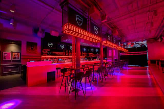 Vibrant event space at Bounce New York with neon bar, ideal for social gatherings.