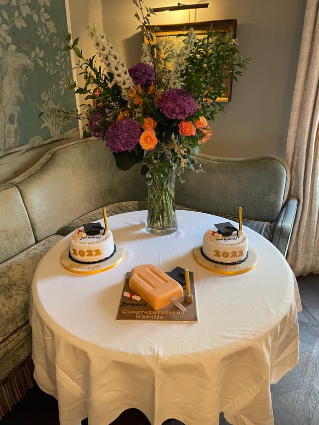 Elegant graduation cake display at No. Fifty Cheyne for a celebratory event.