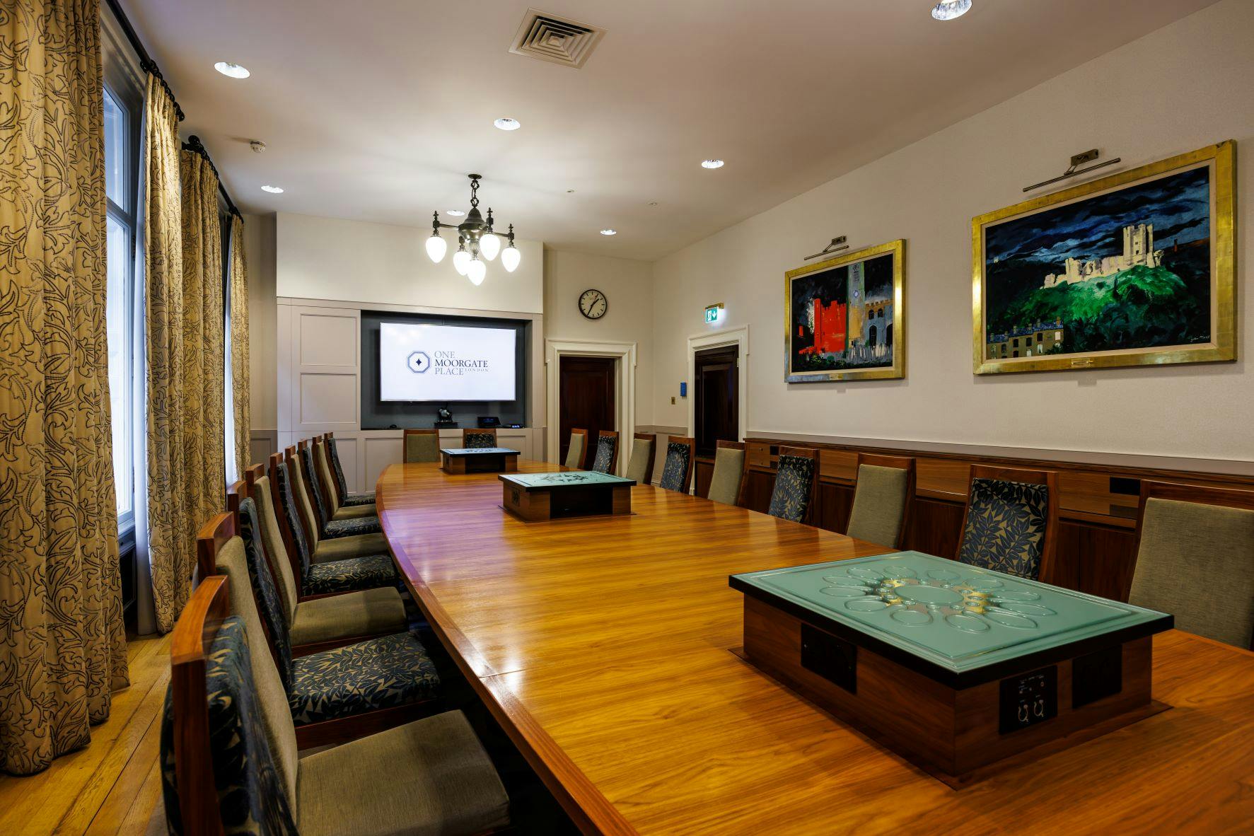 Boardroom at One Moorgate Place with wooden table, ideal for meetings and presentations.