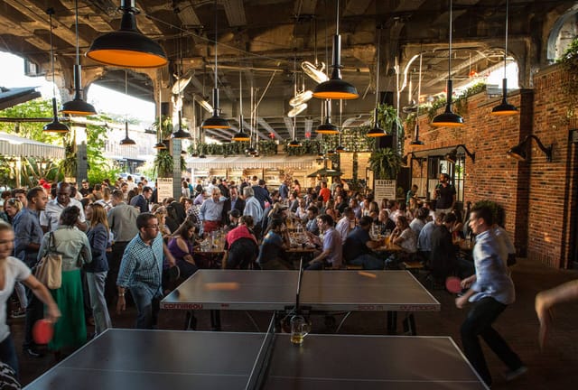 Biergarten Garden Room: vibrant event space with ping pong tables for corporate networking.