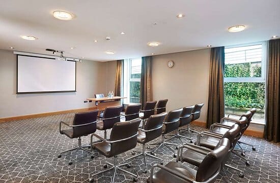 Weatherill Suite meeting room at Hilton London Croydon, featuring large screen and natural light.