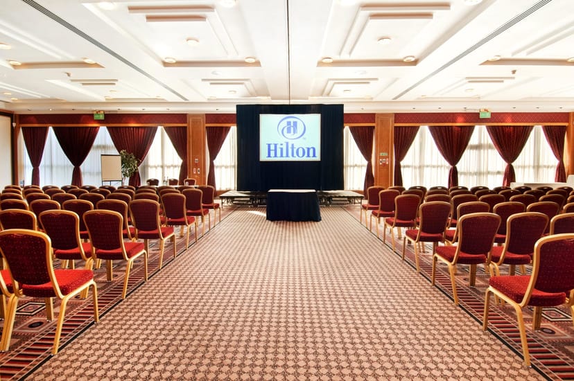 Weatherill Suite conference room with red chairs, ideal for corporate meetings and presentations.