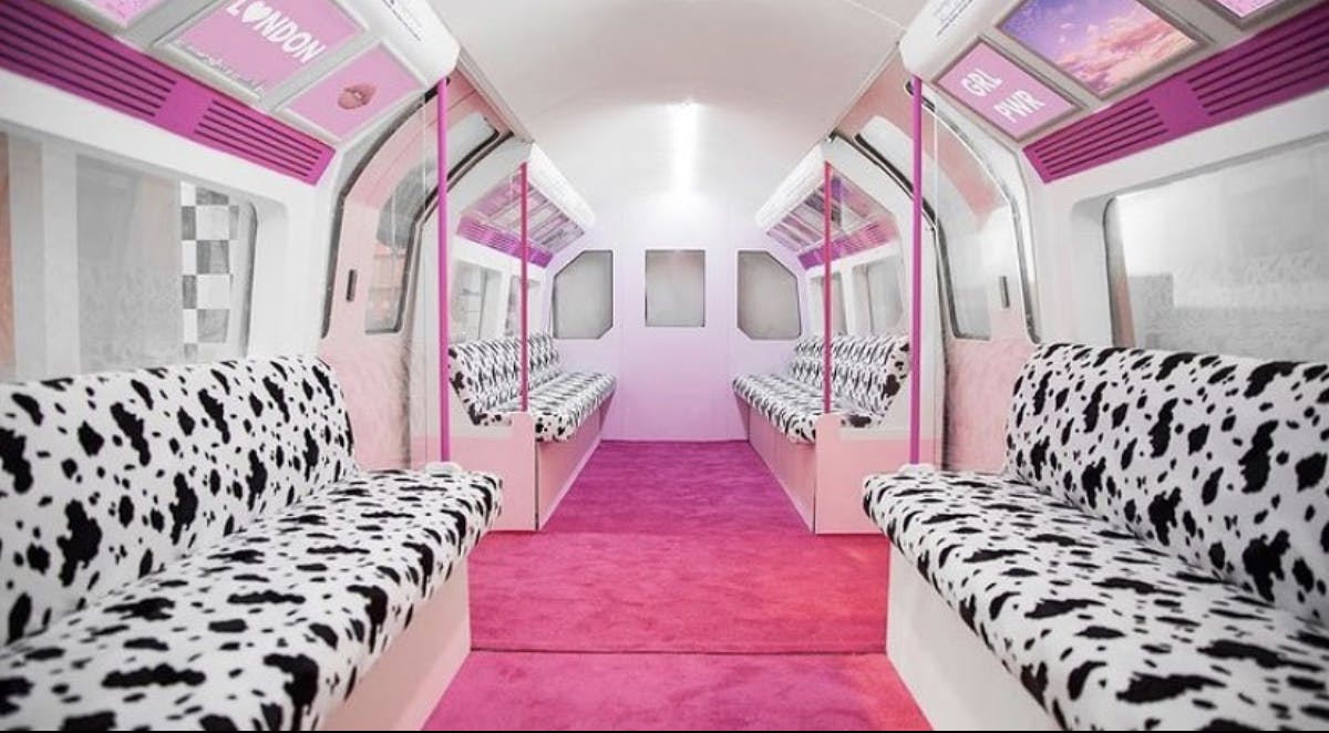 Vibrant subway-themed event space with cow-print seating for unique gatherings.