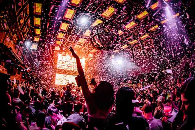 Vibrant Marquee New York event with confetti, lively crowd celebrating a party.
