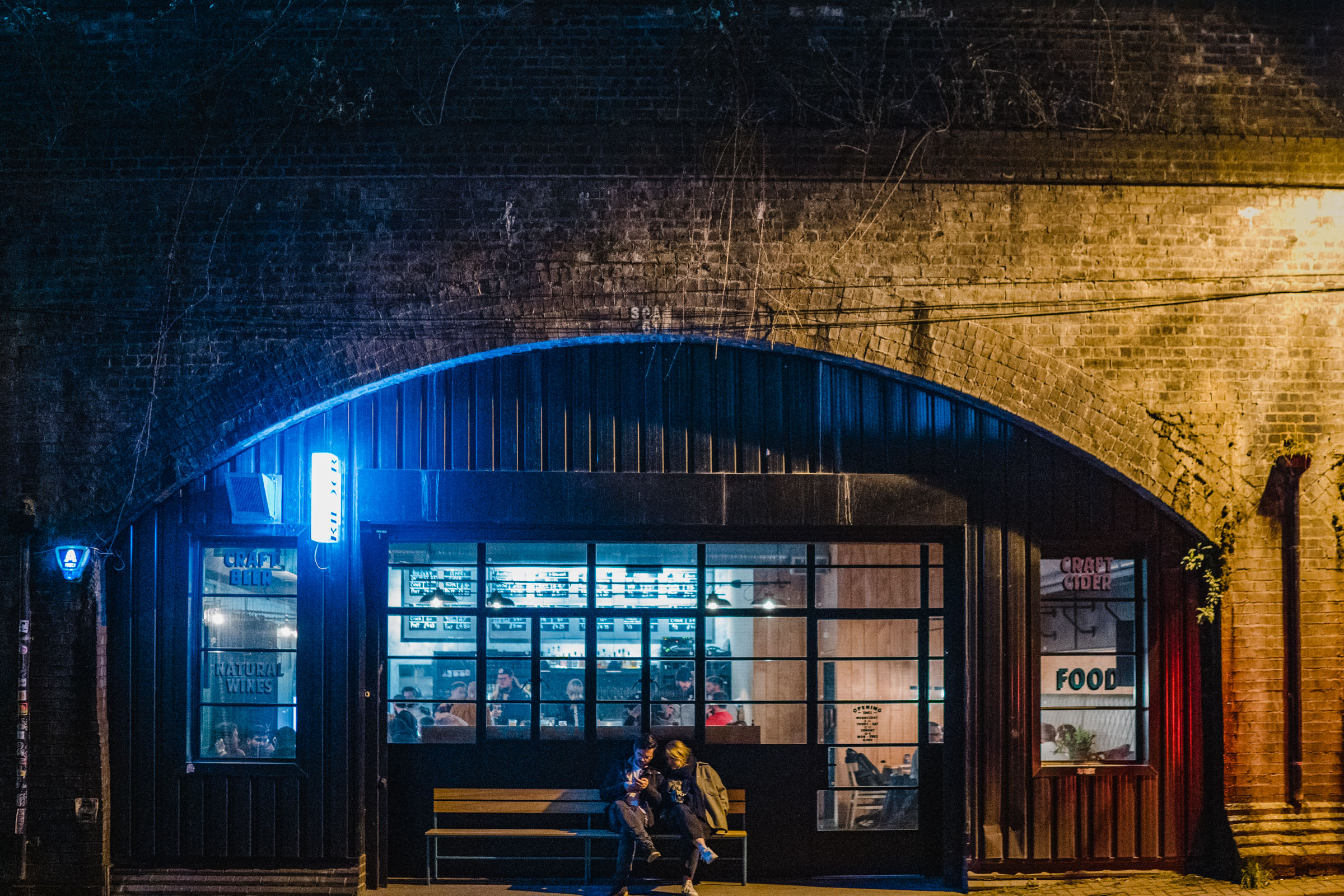 Cozy Kilder bar with warm lighting, perfect for networking events and gatherings. - Banner