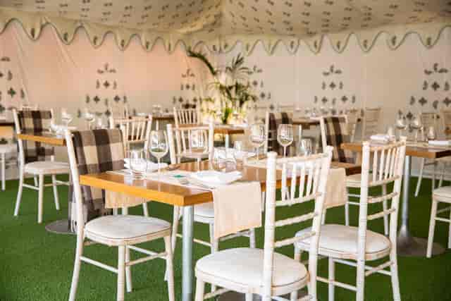 Elegant marquee event space with stylish tables, ideal for upscale gatherings and celebrations.