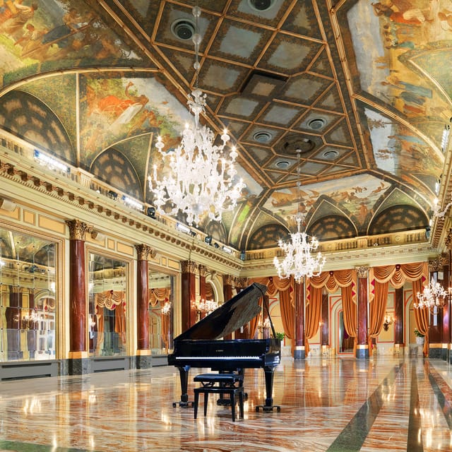 Elegant Ritz Ballroom in St Regis, Rome with grand piano for gala dinners and receptions.
