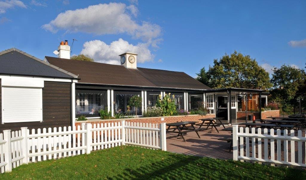 Charming outdoor venue with spacious patio and gardens for events and gatherings.