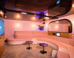Modern meeting space with soft pink seating for intimate gatherings at BAM Karaoke Box.