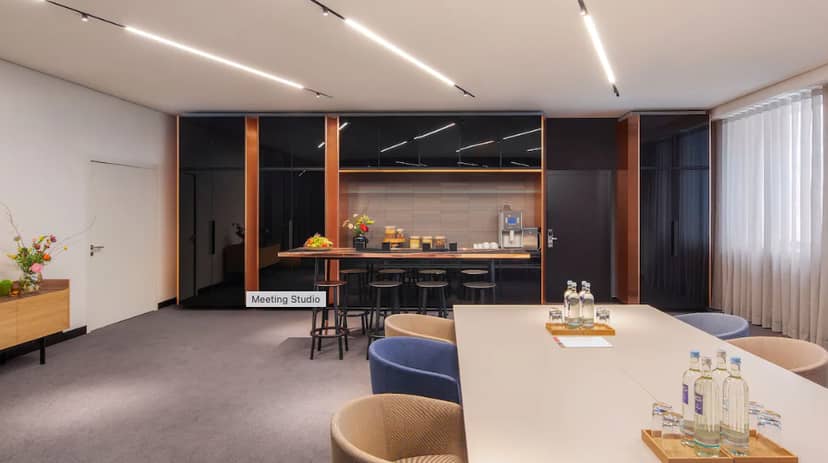 Modern meeting space in Andaz Munich with large table for collaboration and networking.