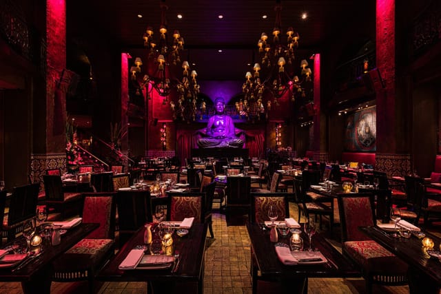 Semi-private dining space at Buddha-Bar with dramatic lighting for upscale events.