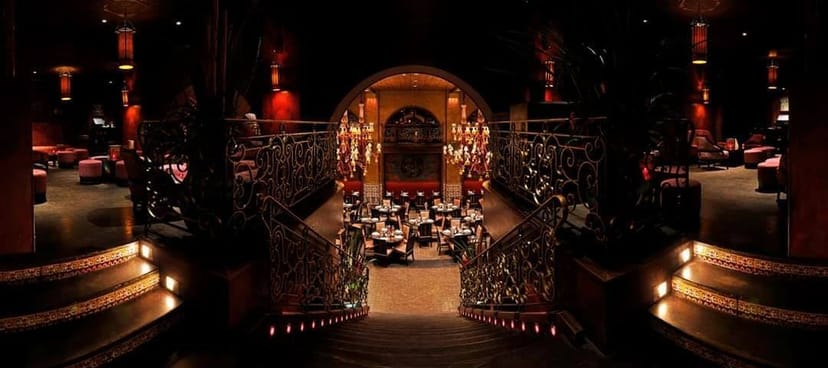 Elegant Buddha-Bar mezzanine with grand staircase, ideal for upscale events and gatherings.