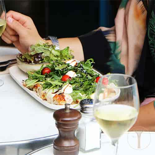 Whole Venue in La Reverie: vibrant dish with greens, tomatoes, and white wine for events.