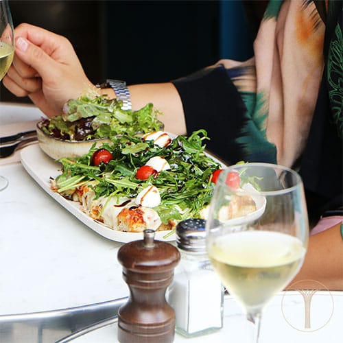 Whole Venue in La Reverie: vibrant dish with greens, tomatoes, and white wine for events.