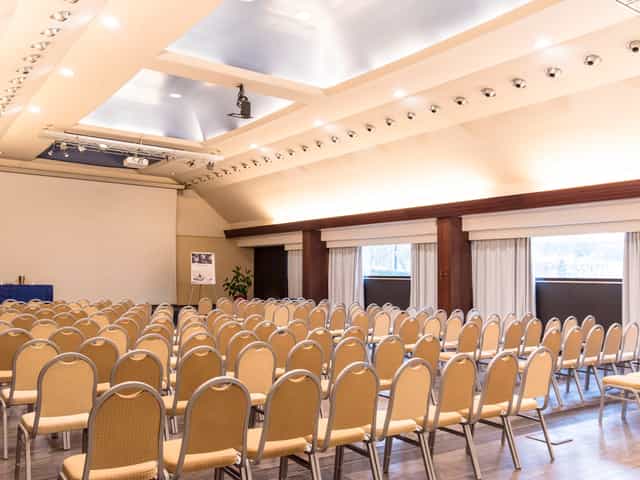 Spacious Mercure Roma West meeting room set for a conference with beige chairs.