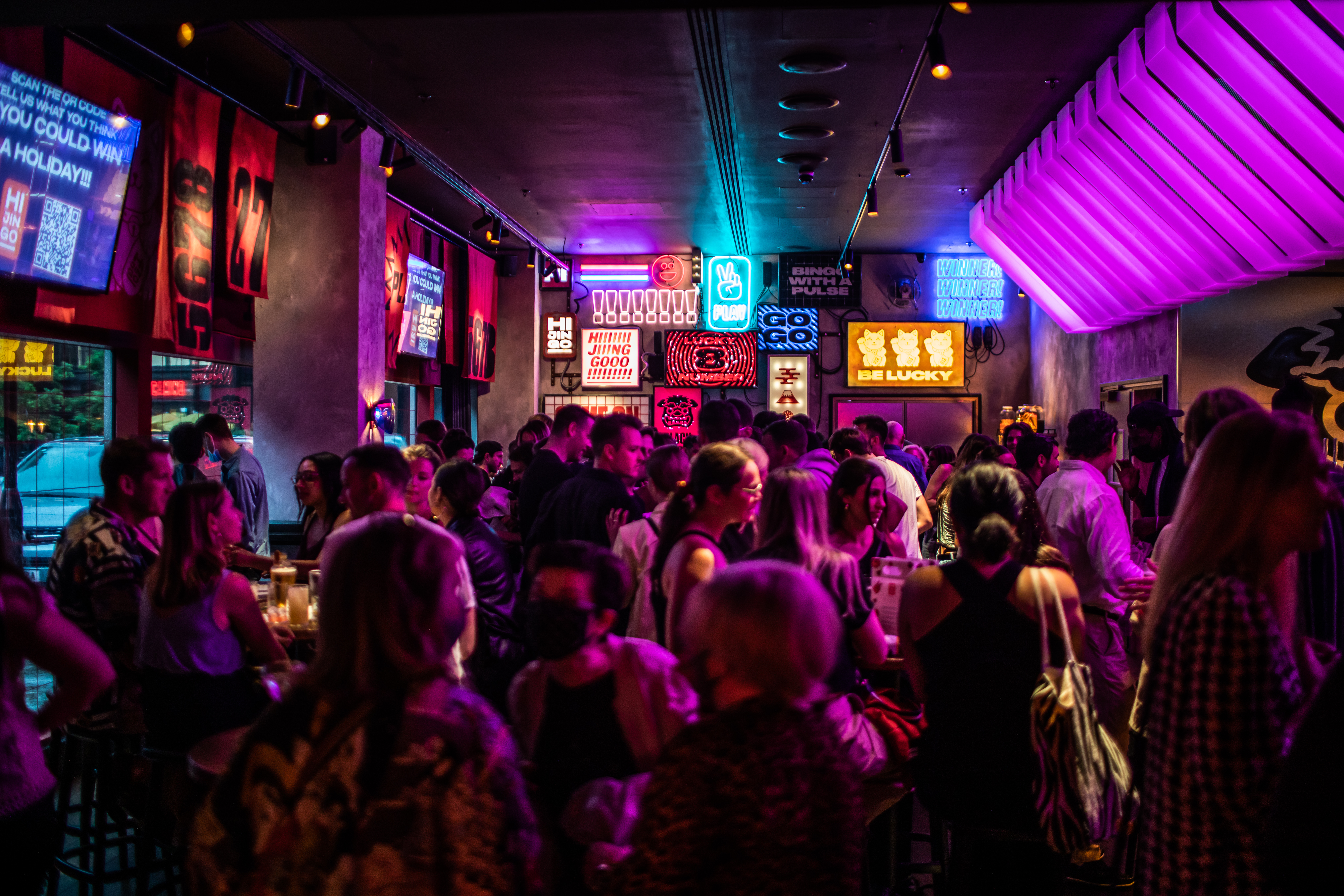 Vibrant networking event at Lucky Cat Bar with colorful decor and lively atmosphere. - Banner