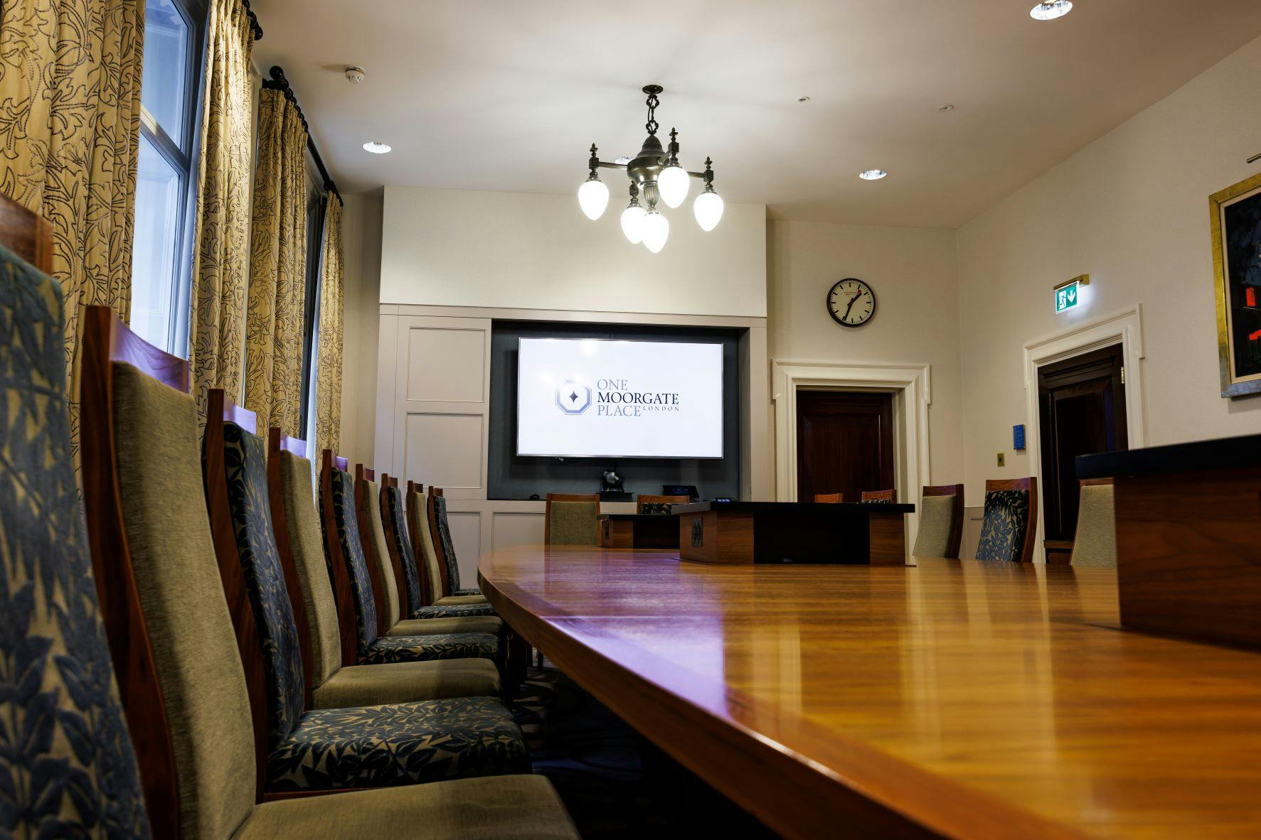 Boardroom at One Moorgate Place with wooden table, ideal for corporate meetings and events.