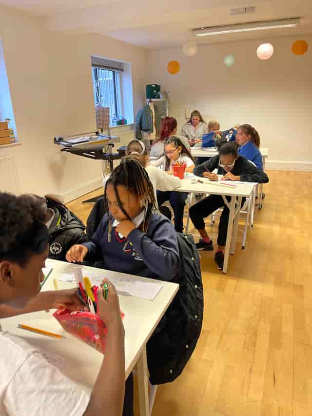 Children engaged in creative activities in a collaborative classroom at The Bop Hub.